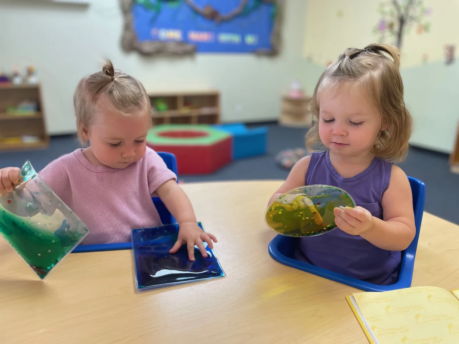 Toddler engaged in calming sensory water play, the kind of regulating activity that helps a depleted nervous system recover