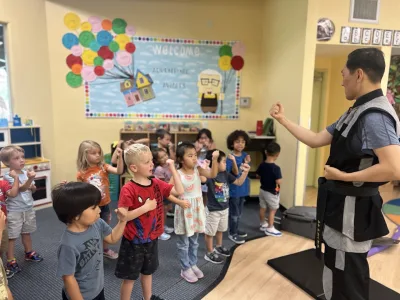 Children participating in dance and fitness enrichment at Village Preschool Academy expressing themselves through movement and creative play