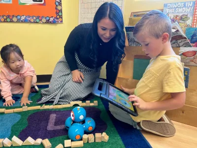 School-age children ages 5-12 at Village Preschool Academy's before and after school care doing art and enrichment activities