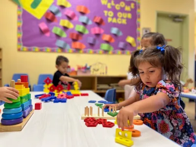 Toddlers at Village Preschool Academy ages 18-30 months engaged in creative play-based learning exploration